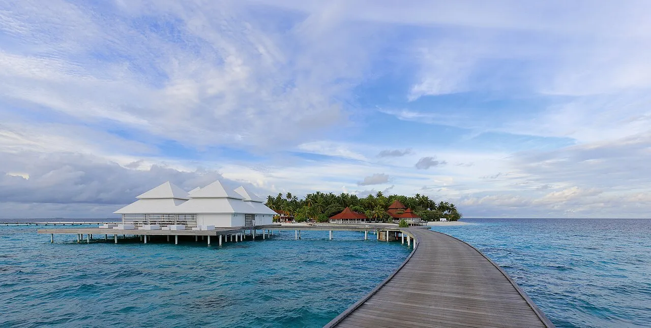 A wooden jetty leading to overwater villas